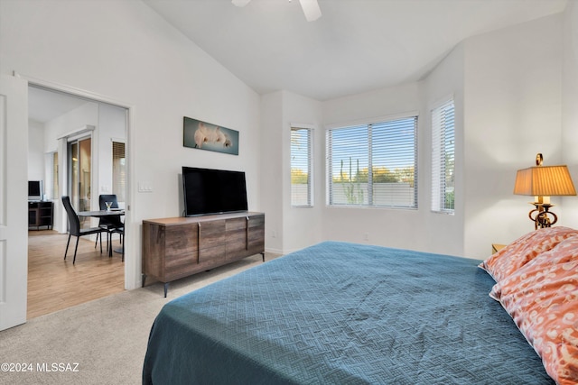 carpeted bedroom featuring ceiling fan and lofted ceiling