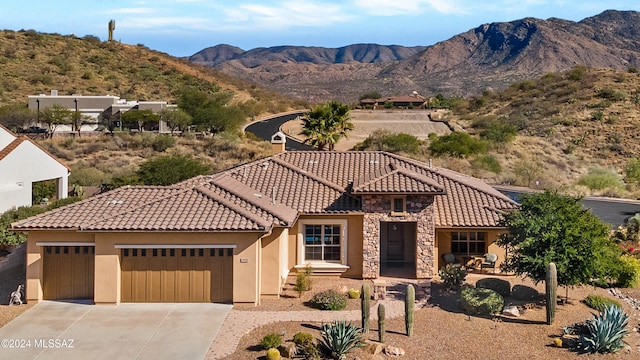 view of front of house featuring a mountain view and a garage