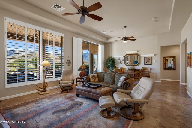 living room with ceiling fan and tile patterned floors