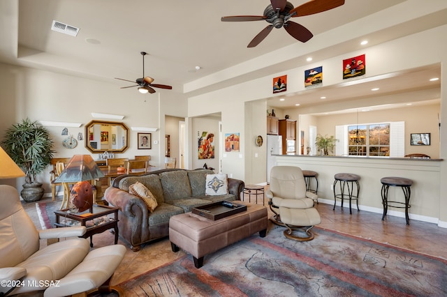 tiled living room with ceiling fan