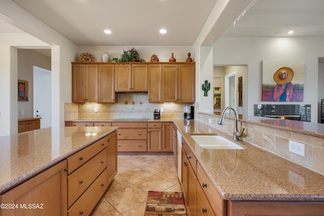 kitchen featuring sink, light stone countertops, light tile patterned floors, black electric stovetop, and decorative backsplash