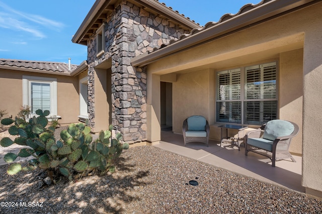 entrance to property featuring a patio