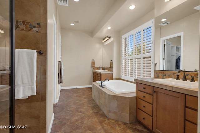 bathroom with shower with separate bathtub and vanity