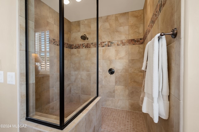 bathroom featuring tile patterned floors and tiled shower