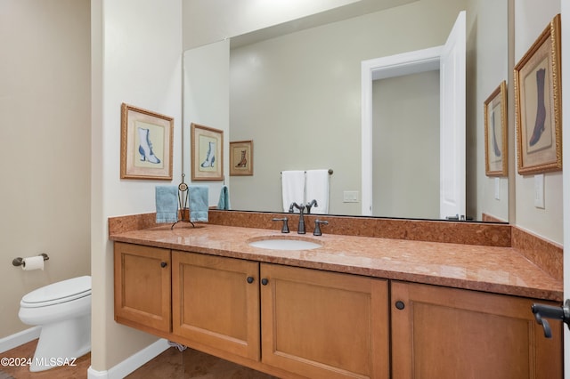 bathroom featuring toilet and vanity