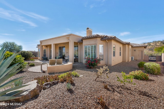 rear view of property featuring central AC unit, a patio, and outdoor lounge area