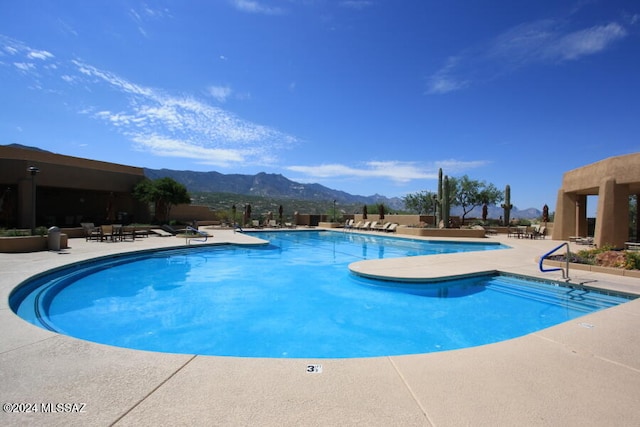 view of pool featuring a mountain view and a patio