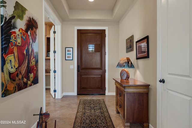 foyer with a tray ceiling