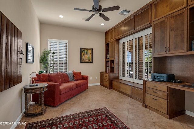 living room featuring ceiling fan and light tile patterned floors