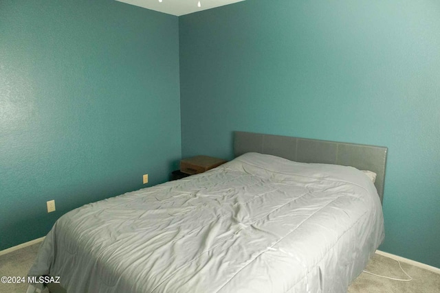 bedroom with light colored carpet