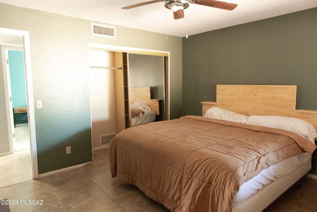 bedroom with ceiling fan and tile patterned flooring