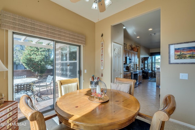 dining room featuring light tile patterned floors, plenty of natural light, and ceiling fan