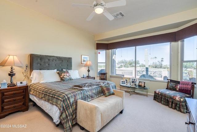 bedroom with ceiling fan and light colored carpet