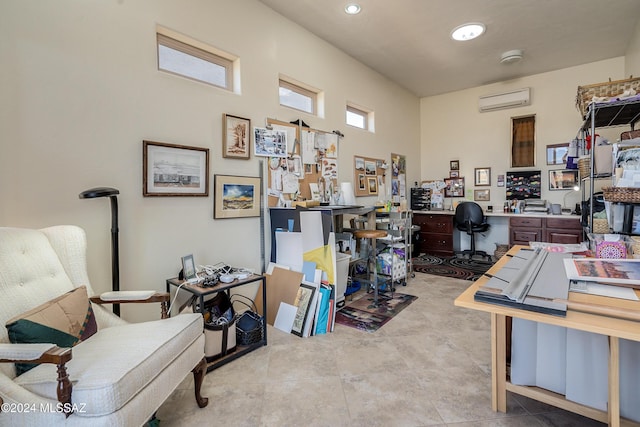 office space with an AC wall unit and a towering ceiling