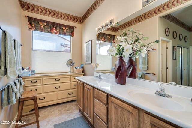 bathroom with plenty of natural light, vanity, and tile patterned flooring