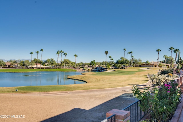 view of property's community with a yard and a water view