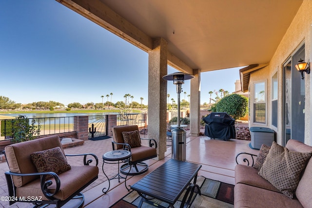 exterior space featuring grilling area and a water view