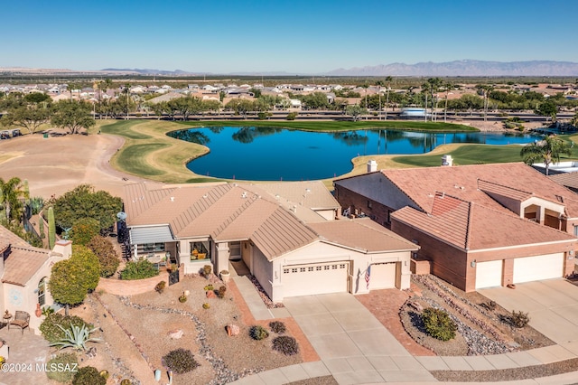 drone / aerial view with a water and mountain view