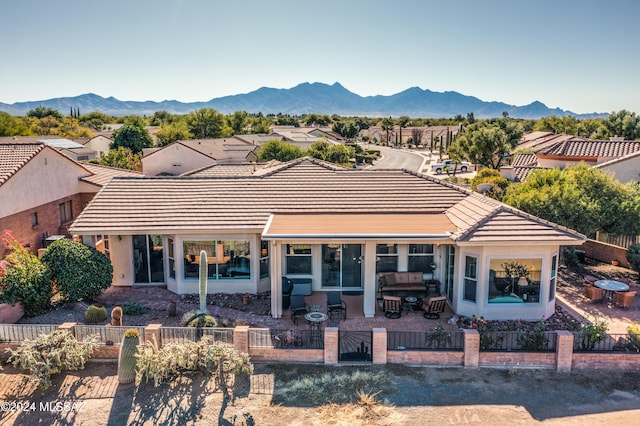 rear view of property with a mountain view and a patio