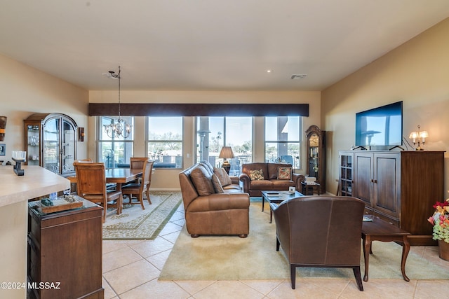 living room featuring light tile patterned flooring and a chandelier