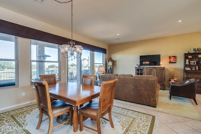 dining space with a chandelier, light tile patterned floors, and a wealth of natural light