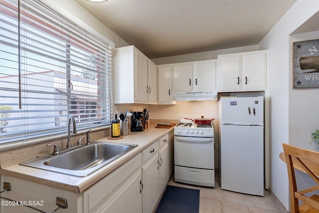 kitchen with white appliances, sink, a healthy amount of sunlight, and white cabinets