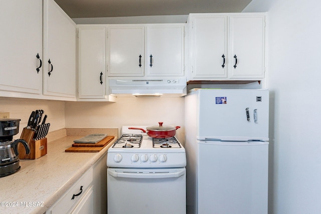 kitchen featuring white appliances and white cabinets