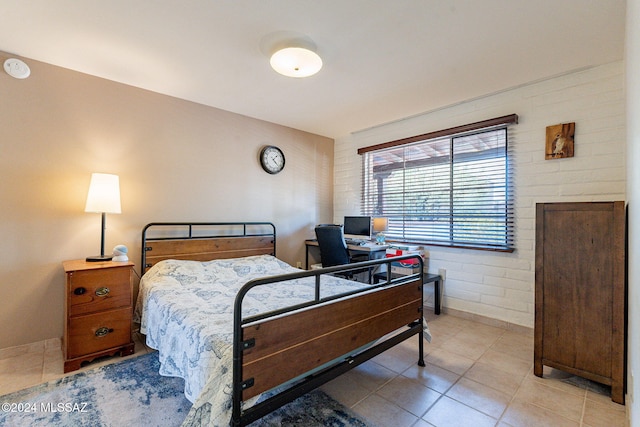 tiled bedroom with brick wall