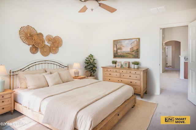 5567 W Dove Loft Dr, Marana, AZ 85658 - bedroom with arched walkways, light colored carpet, and ceiling fan