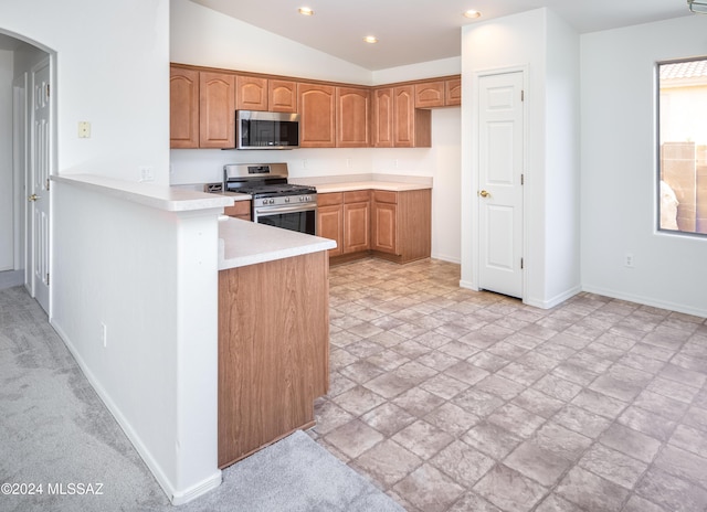 5567 W Dove Loft Dr, Marana, AZ 85658 - kitchen featuring stainless steel appliances, arched walkways, stone tile floors, light countertops, and recessed lighting