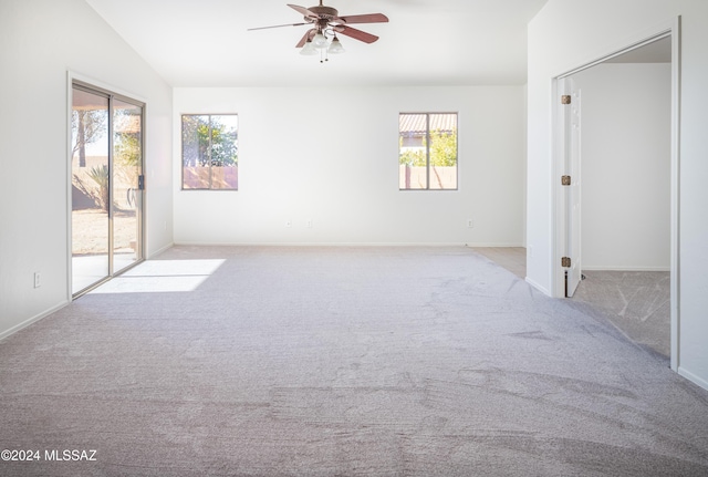 5567 W Dove Loft Dr, Marana, AZ 85658 - spare room featuring ceiling fan, carpet, baseboards, and lofted ceiling