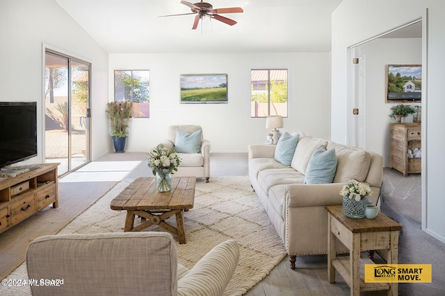 5567 W Dove Loft Dr, Marana, AZ 85658 - living area with a ceiling fan, vaulted ceiling, carpet floors, and baseboards