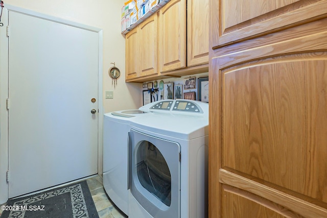 laundry room with cabinets and washer and dryer