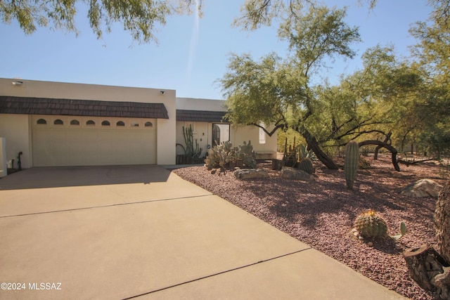 pueblo-style home with a garage