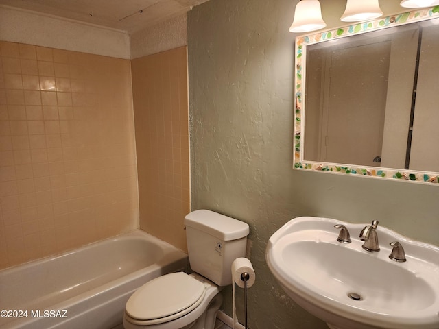 full bathroom featuring toilet, tiled shower / bath, and sink