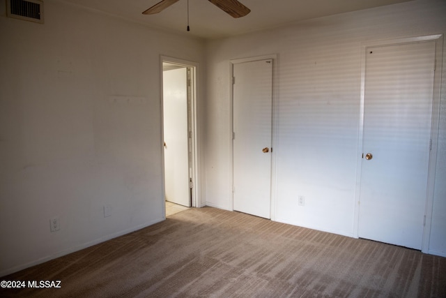 unfurnished bedroom with ceiling fan and light colored carpet