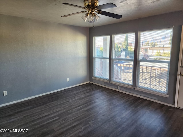 unfurnished room featuring a textured ceiling, dark hardwood / wood-style flooring, and ceiling fan