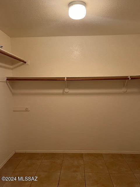 spacious closet with tile patterned floors