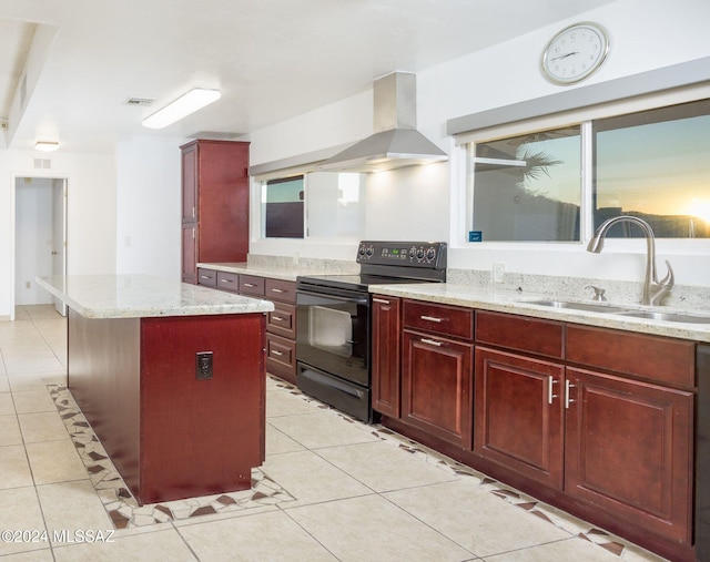 kitchen featuring light stone counters, sink, black range with electric stovetop, wall chimney range hood, and a kitchen island