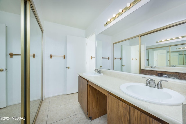 bathroom with tile patterned flooring and vanity