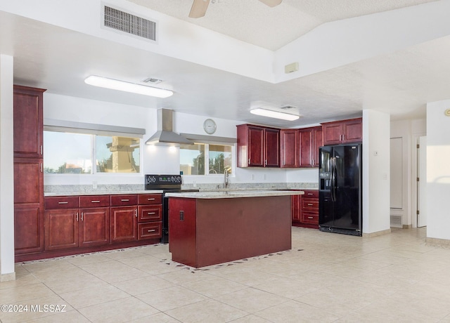 kitchen with black appliances, a healthy amount of sunlight, a center island, and ceiling fan