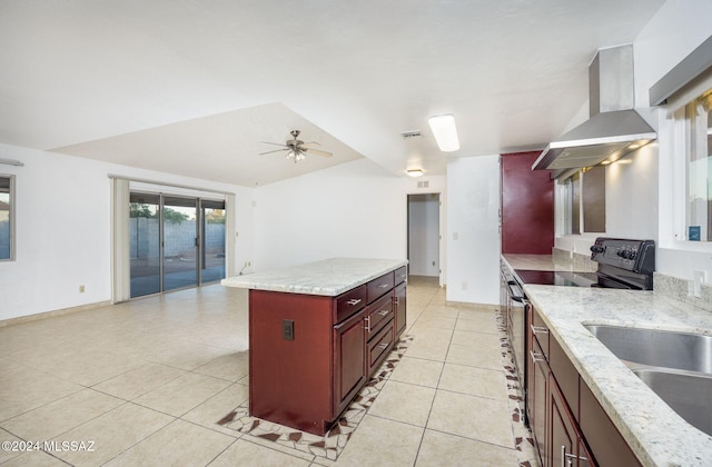 kitchen featuring light stone counters, wall chimney exhaust hood, sink, black range with electric cooktop, and ceiling fan