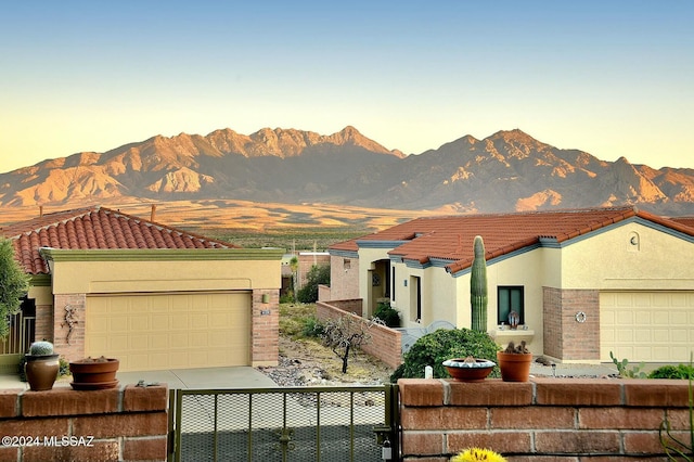 4115 S Constancia Ct, Green Valley, AZ 85622 - mediterranean / spanish-style home featuring a tiled roof, a mountain view, stucco siding, and an attached garage