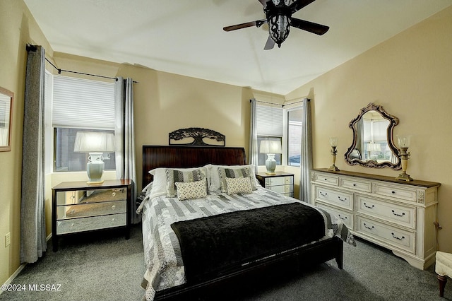 bedroom with dark colored carpet and ceiling fan