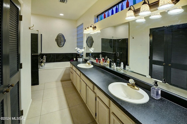 bathroom with tile patterned flooring, vanity, and plus walk in shower