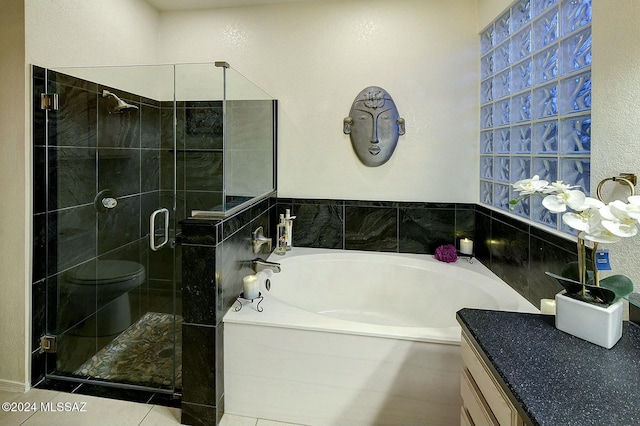 full bathroom with tile patterned flooring, vanity, toilet, and independent shower and bath