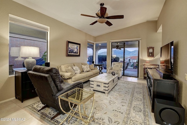 living room with ceiling fan, light tile patterned floors, and vaulted ceiling