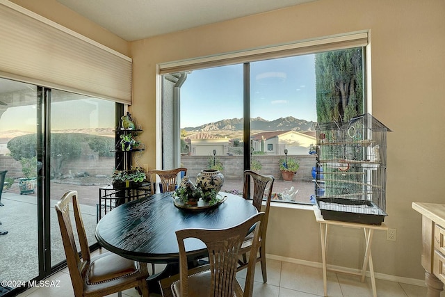 dining space featuring a mountain view and light tile patterned floors