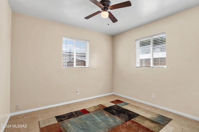 tiled empty room featuring ceiling fan