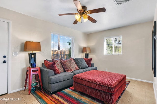 living room with ceiling fan and light tile patterned flooring